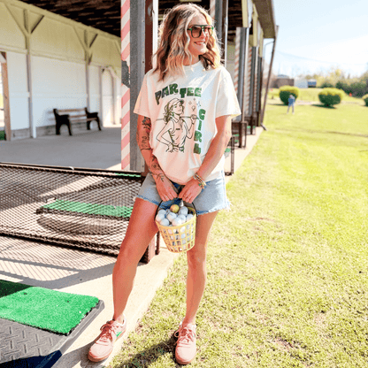 Woman holding a basket of golf balls on a driving range