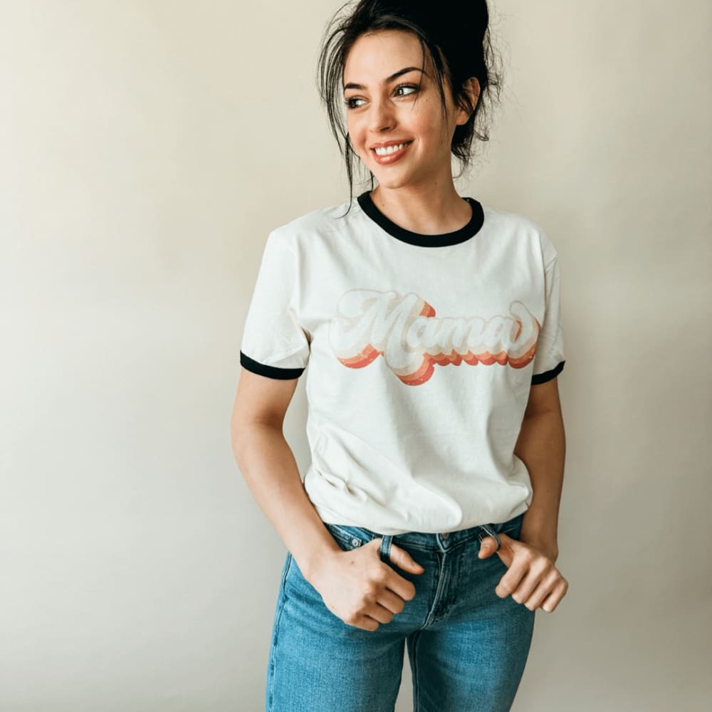 https://mountainmoverz.com/cdn/shop/files/mama-retro-ringer-tee-adult-all-mom-shirt-size-chart-video-spo-default-mommy-apparel-mountain-moverz-clothing-face-jeans-601_1200x.jpg?v=1700060916
