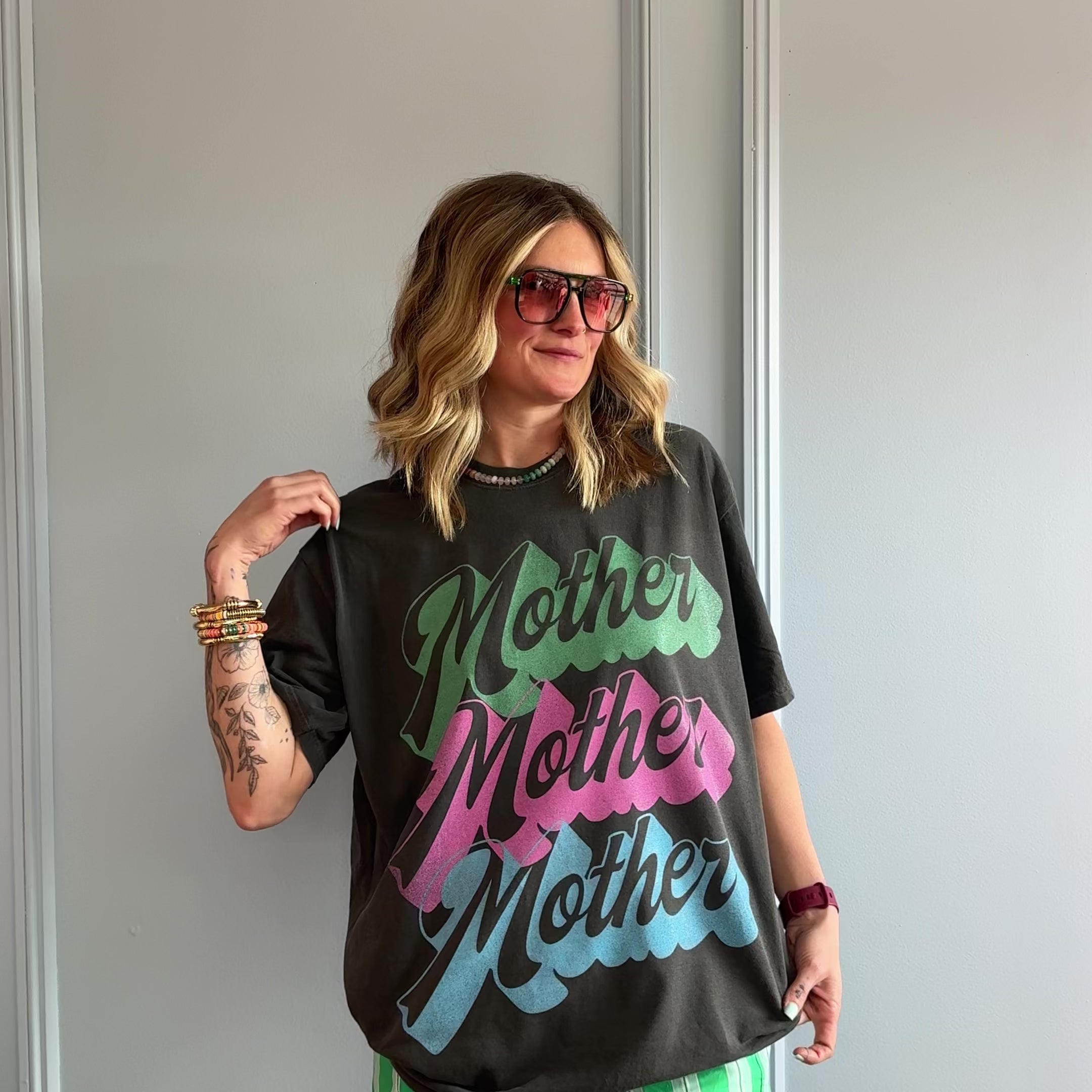 model wearing colorful neon mother tee
