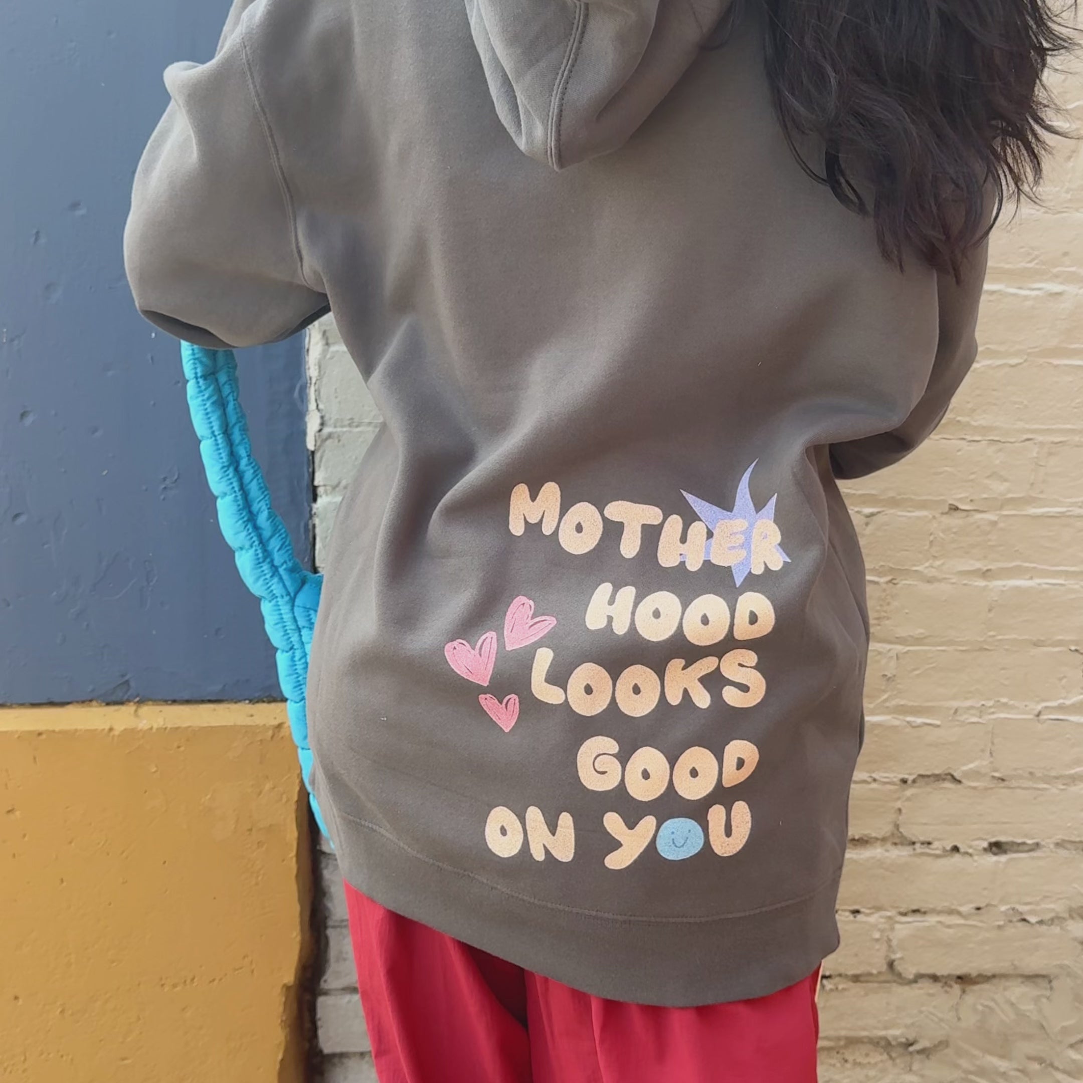woman wearing motherhood hoodie