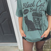 woman wearing black cat book club tee